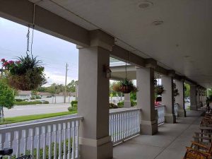 Hanging Baskets on porch between columns