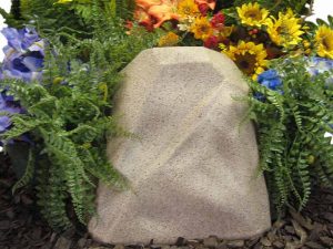 Sandstone watering rock surrounded by plants