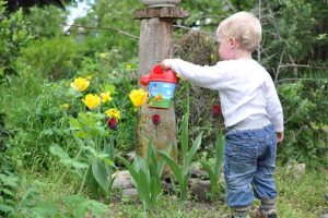 Child with Watering Pot and Flowers